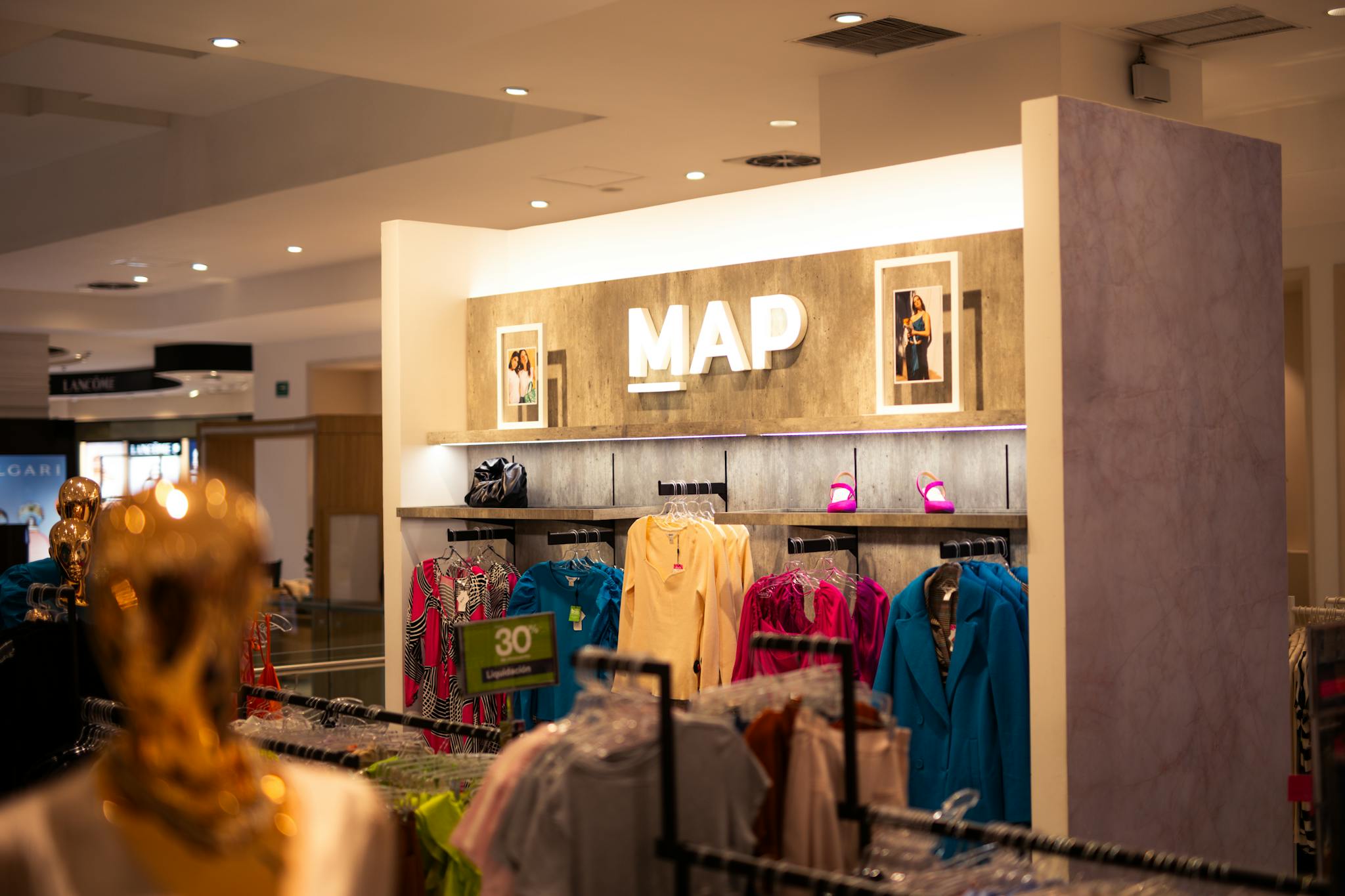 Explore a fashion retail store interior featuring designer clothing and vibrant colors, ideal for shopping enthusiasts.